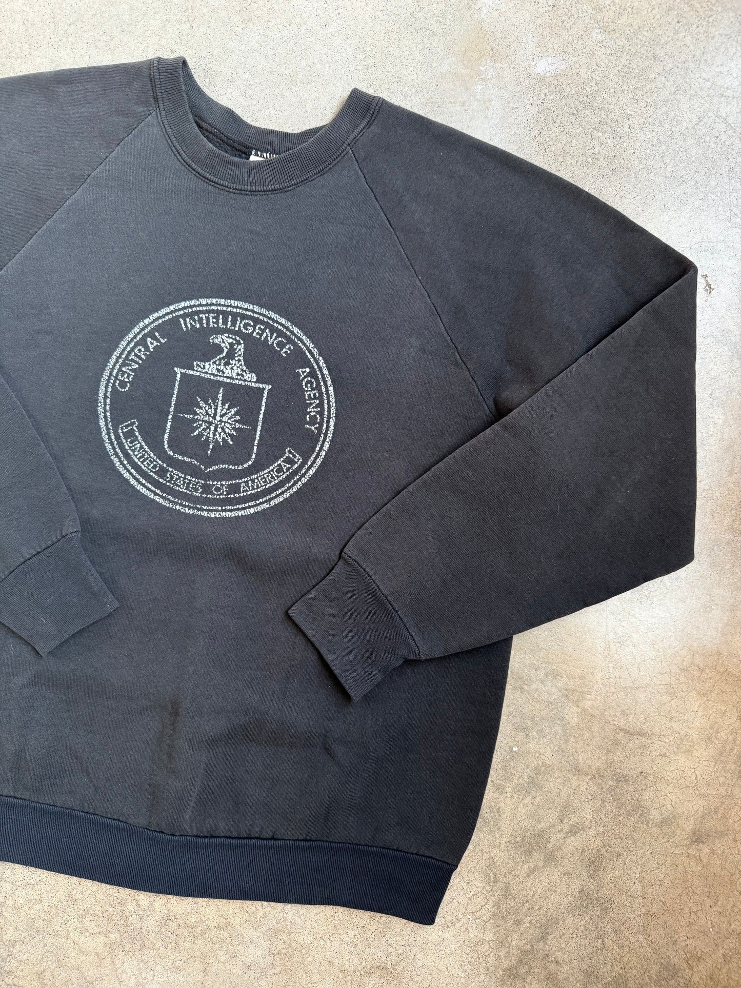 Vintage 1980s Washed Black Central Intelligence Agency Raglan Sweatshirt | Large