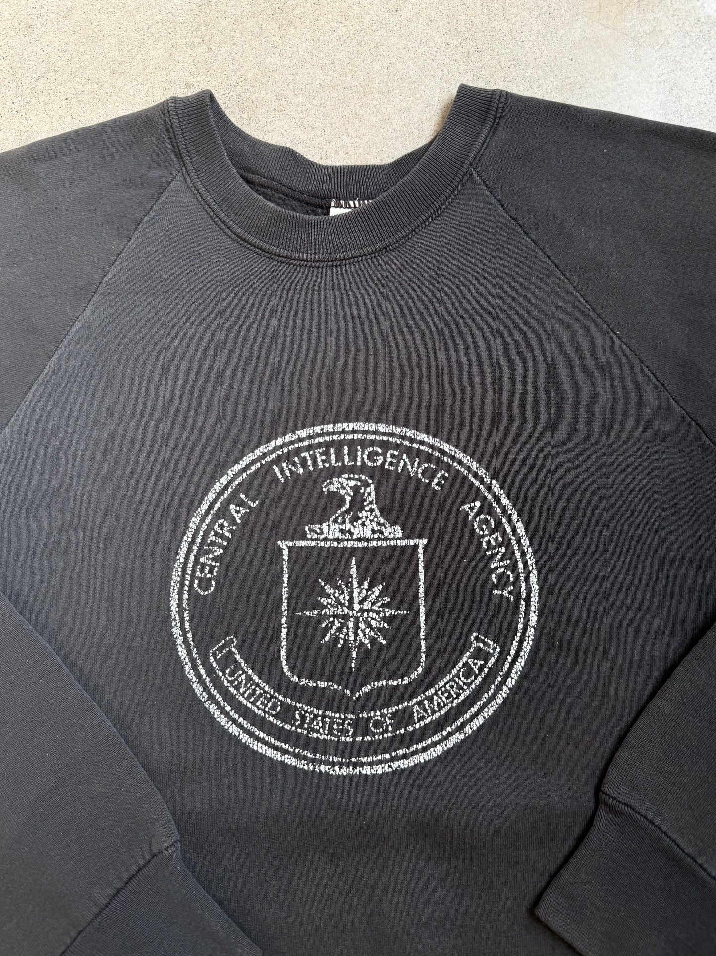 Vintage 1980s Washed Black Central Intelligence Agency Raglan Sweatshirt | Large